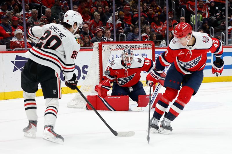 Jan 3, 2026; Washington, District of Columbia, USA; Washington Capitals goaltender Logan Thompson (48) prepares to make a save on Chicago Blackhawks center Ryan Greene (20) as Capitals defenseman Martin Fehérváry (42) defends during the second period at Capital One Arena. Mandatory Credit: Geoff Burke-Imagn Images