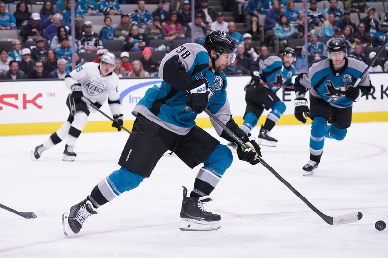Nov 20, 2025; San Jose, California, USA; San Jose Sharks defenseman Mario Ferraro (38) advances the puck in the second period against the Los Angeles Kings at SAP Center at San Jose. Mandatory Credit: David Gonzales-Imagn Images