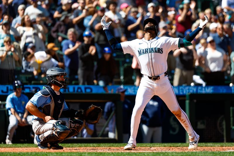 Aug 28, 2024; Seattle, Washington, USA; Seattle Mariners right fielder Victor Robles (10) celebrates after hitting a two-run home run against the Tampa Bay Rays during the fifth inning at T-Mobile Park. Tampa Bay Rays catcher Ben Rortvedt (30) squats at left. Mandatory Credit: Joe Nicholson-USA TODAY Sports