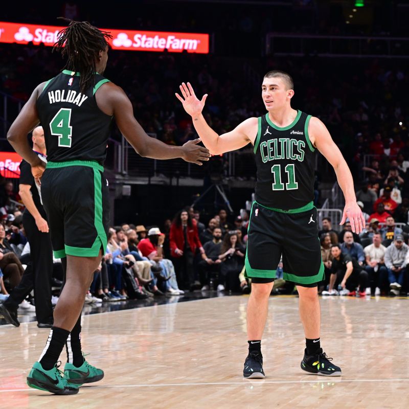 ATLANTA, GA - NOVEMBER 4: Payton Pritchard #11 of the Boston Celtics high fives Jrue Holiday #4 during the game against the Atlanta Hawks on November 4, 2024 at State Farm Arena in Atlanta, Georgia.  NOTE TO USER: User expressly acknowledges and agrees that, by downloading and/or using this Photograph, user is consenting to the terms and conditions of the Getty Images License Agreement. Mandatory Copyright Notice: Copyright 2024 NBAE (Photo by Adam Hagy/NBAE via Getty Images)