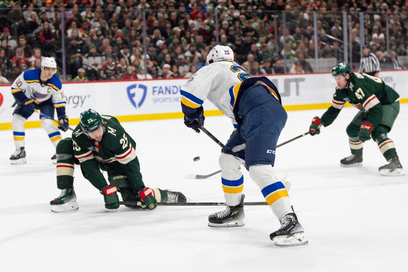 Jan 7, 2025; Saint Paul, Minnesota, USA; St. Louis Blues center Jordan Kyrou (25) passes to center Brayden Schenn (10) around the defense of Minnesota Wild defenseman Jonas Brodin (25) and defenseman Declan Chisholm (47) in the first period at Xcel Energy Center. Mandatory Credit: Matt Blewett-Imagn Images