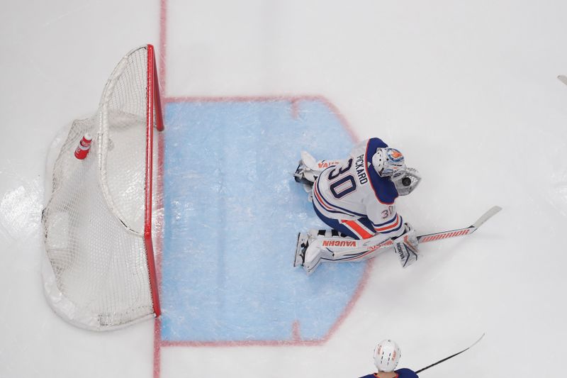 Mar 7, 2024; Columbus, Ohio, USA; Edmonton Oilers goalie Calvin Pickard (30) makes a glove save against the Columbus Blue Jackets during the second period at Nationwide Arena. Mandatory Credit: Russell LaBounty-USA TODAY Sports