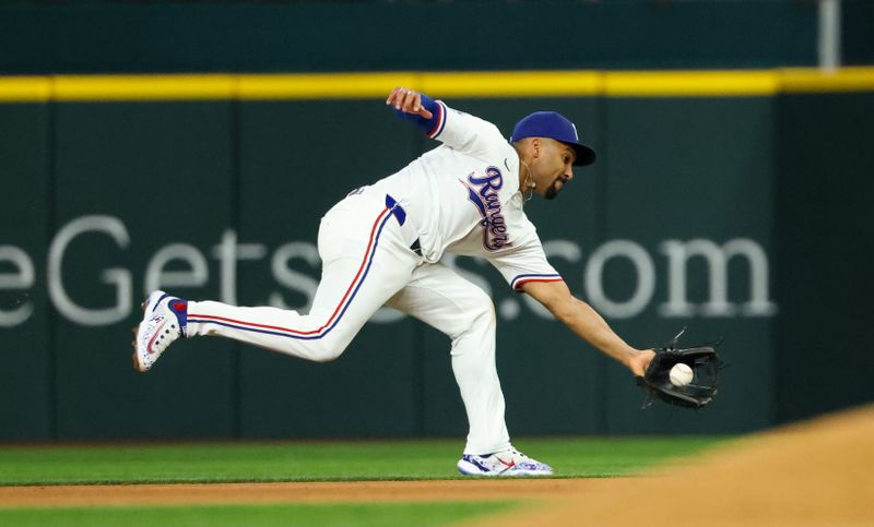 Aug 20, 2024; Arlington, Texas, USA; Texas Rangers second baseman Marcus Semien (2) fields a ground ball during the eighth inning against the Pittsburgh Pirates  at Globe Life Field. Mandatory Credit: Kevin Jairaj-USA TODAY Sports