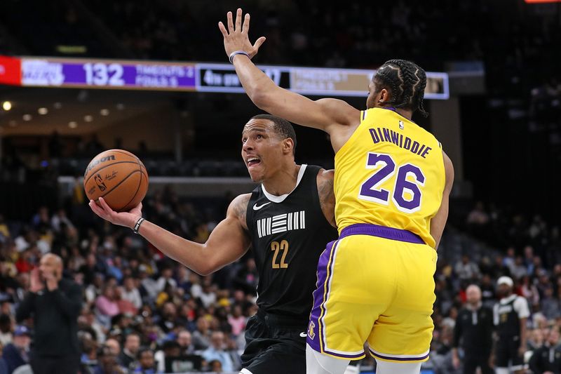 MEMPHIS, TENNESSEE - MARCH 27: Desmond Bane #22 of the Memphis Grizzlies drives to the basket against Spencer Dinwiddie #26 of the Los Angeles Lakers during the second half at FedExForum on March 27, 2024 in Memphis, Tennessee. NOTE TO USER: User expressly acknowledges and agrees that, by downloading and or using this photograph, User is consenting to the terms and conditions of the Getty Images License Agreement. (Photo by Justin Ford/Getty Images)