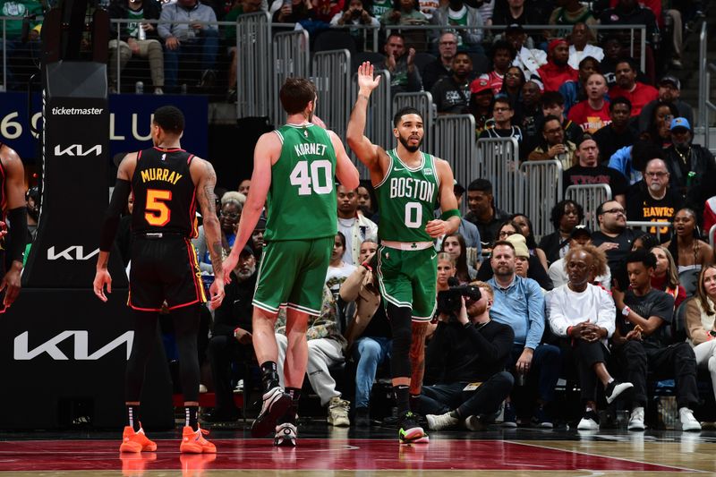 ATLANTA, GA - MARCH 28: Jayson Tatum #0 of the Boston Celtics high fives Luke Kornet #40 during the game against the Atlanta Hawks on March 28, 2024 at State Farm Arena in Atlanta, Georgia.  NOTE TO USER: User expressly acknowledges and agrees that, by downloading and/or using this Photograph, user is consenting to the terms and conditions of the Getty Images License Agreement. Mandatory Copyright Notice: Copyright 2024 NBAE (Photo by Scott Cunningham/NBAE via Getty Images)