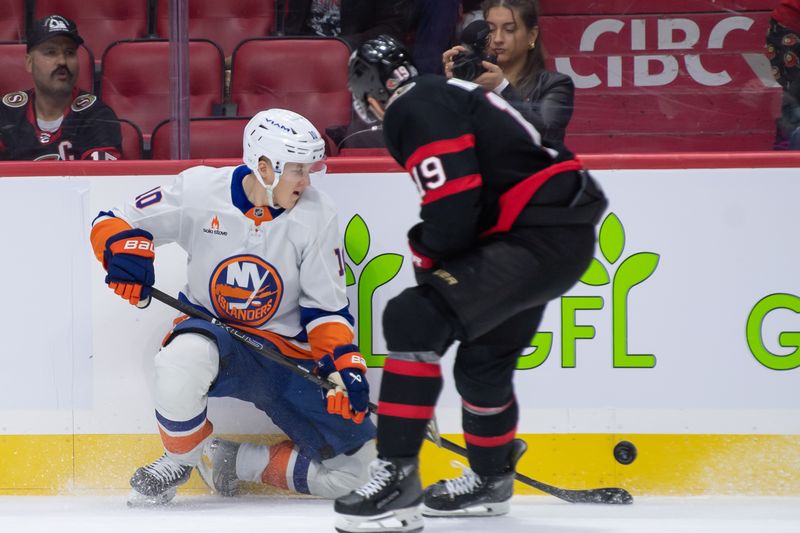 Dec 8, 2024; Ottawa, Ontario, CAN; New York Islanders right wing Simon Holmstrom (10) battles with Ottawa Senators right wing Drake Batherson (19) for control of the puck in the first period at the Canadian Tire Centre. Mandatory Credit: Marc DesRosiers-Imagn Images