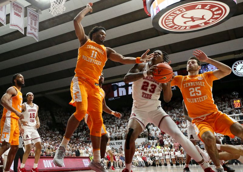 Mar 2, 2024; Tuscaloosa, Alabama, USA;  Tennessee forward Tobe Awaka (11) and Tennessee guard Santiago Vescovi (25) attempt to stop a shot by Alabama forward Nick Pringle (23) at Coleman Coliseum. Mandatory Credit: Gary Cosby Jr.-USA TODAY Sports