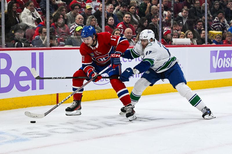 Nov 12, 2023; Montreal, Quebec, CAN; Vancouver Canucks defenseman Filip Hronek (17) defends against Montreal Canadiens right wing Josh Anderson (17) during the second period at Bell Centre. Mandatory Credit: David Kirouac-USA TODAY Sports