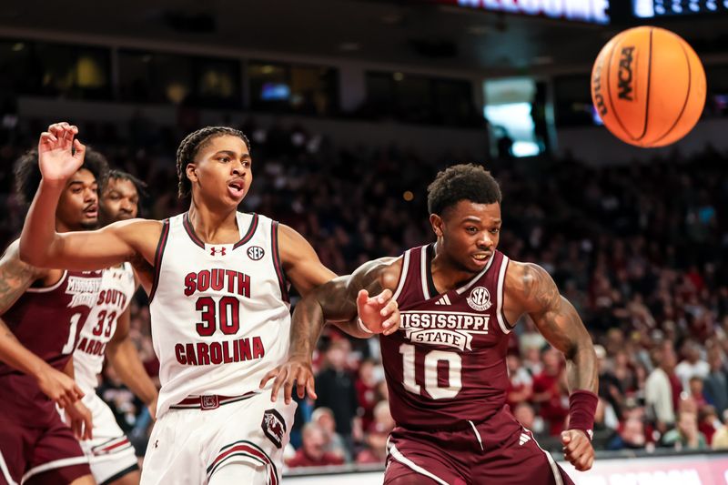 Jan 6, 2024; Columbia, South Carolina, USA; South Carolina Gamecocks forward Collin Murray-Boyles (30) and Mississippi State Bulldogs guard Dashawn Davis (10) battle for the ball in the first half at Colonial Life Arena. Mandatory Credit: Jeff Blake-USA TODAY Sports