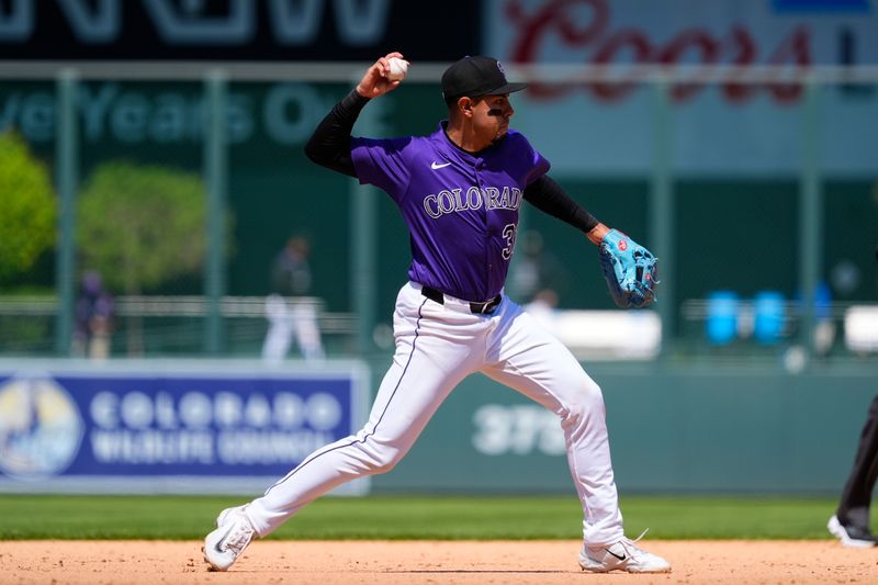 May 8, 2025; Denver, Colorado, USA; Colorado Rockies second base Alan Trejo (31) fields the ball seventh inning against the Detroit Tigers at Coors Field. Mandatory Credit: Ron Chenoy-Imagn Images