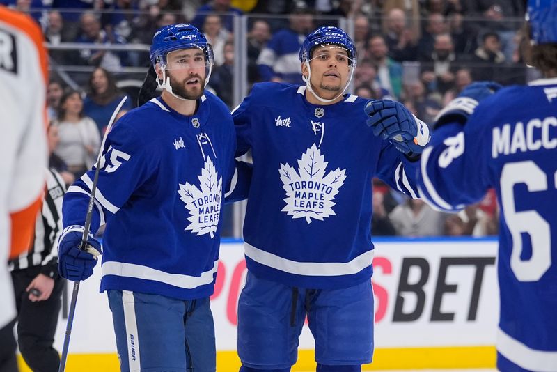 Mar 2, 2026; Toronto, Ontario, CAN; Toronto Maple Leafs forward Dakota Joshua (center) gets congratulated by forward Nick Roy (55) and forward Matias Maccelli (63) after scoring against the Philadelphia Flyers during the first period at Scotiabank Arena. Mandatory Credit: John E. Sokolowski-Imagn Images