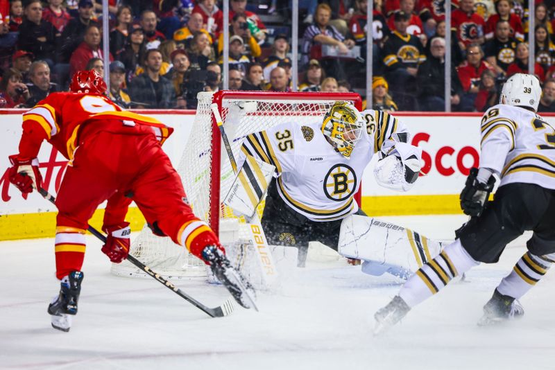 Feb 22, 2024; Calgary, Alberta, CAN; Boston Bruins goaltender Linus Ullmark (35) makes a save against Calgary Flames left wing Andrei Kuzmenko (96) during the second period at Scotiabank Saddledome. Mandatory Credit: Sergei Belski-USA TODAY Sports