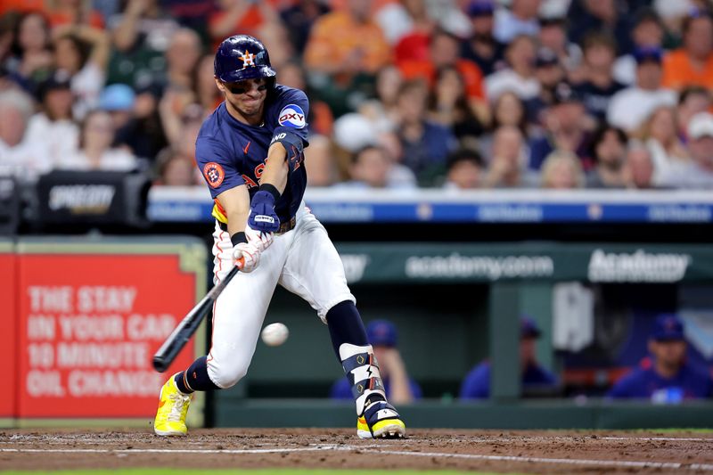 Jun 29, 2025; Houston, Texas, USA; Houston Astros shortstop Mauricio Dubon (14) hits a single against the Chicago Cubs during the second inning at Daikin Park. Mandatory Credit: Erik Williams-Imagn Images