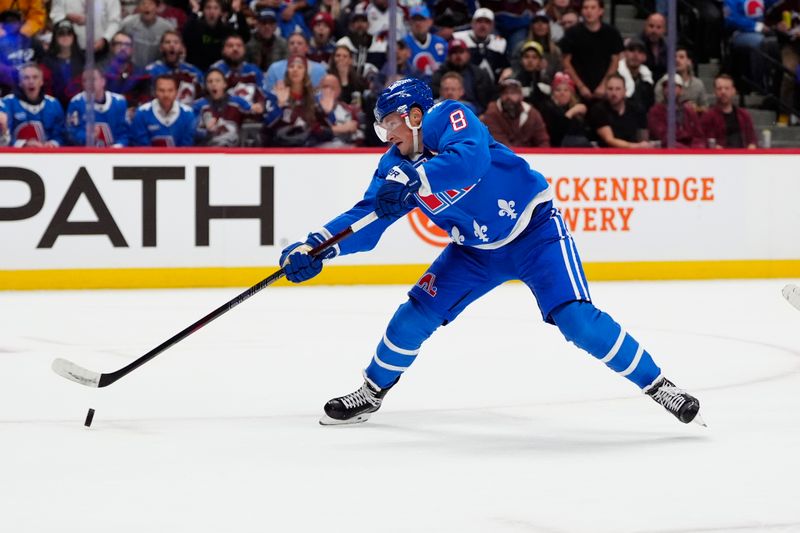 Oct 23, 2025; Denver, Colorado, USA; Colorado Avalanche defenseman Cale Makar (8) shoots the puck in the second period against the Carolina Hurricanes at Ball Arena. Mandatory Credit: Ron Chenoy-Imagn Images