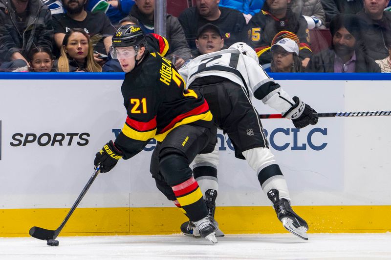 Mar 25, 2024; Vancouver, British Columbia, CAN; Vancouver Canucks forward Nils Hoglander (21) checks Los Angeles Kings defenseman Jordan Spence (21) in the third period at Rogers Arena. Kings won 3 -2. Mandatory Credit: Bob Frid-USA TODAY Sports