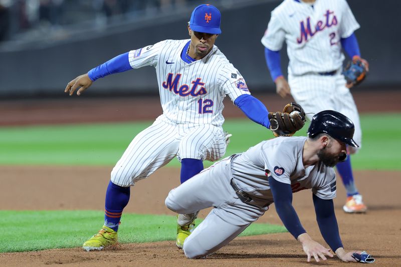 Sep 4, 2024; New York City, New York, USA; New York Mets shortstop Francisco Lindor (12) tags out Boston Red Sox catcher Connor Wong (12) in a run down after Wong was picked off first base during the fourth inning at Citi Field. Mandatory Credit: Brad Penner-Imagn Images