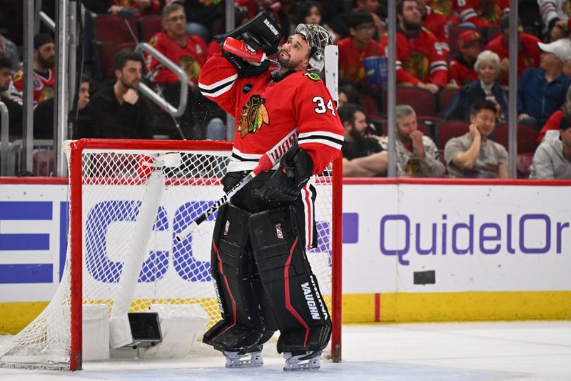 Apr 14, 2024; Chicago, Illinois, USA;  Chicago Blackhawks goaltender Petr Mrazek (34) cools off during a time out in the second period against the Carolina Hurricanes at United Center. Mandatory Credit: Jamie Sabau-USA TODAY Sports