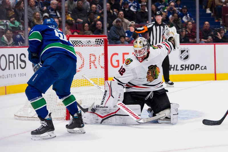 Apr 6, 2023; Vancouver, British Columbia, CAN; Chicago Blackhawks goalie Alex Stalock (32) makes a save on Vancouver Canucks forward Andrei Kuzmenko (96) in the second period at Rogers Arena. Mandatory Credit: Bob Frid-USA TODAY Sports