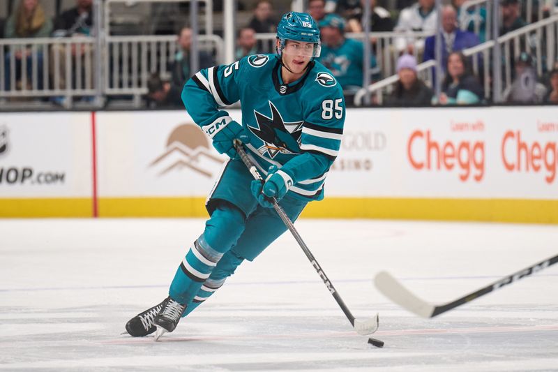 Jan 30, 2024; San Jose, California, USA; San Jose Sharks defenseman Shakir Mukhamadullin (85) plays the puck against the Seattle Kraken during the second period at SAP Center at San Jose. Mandatory Credit: Robert Edwards-USA TODAY Sports