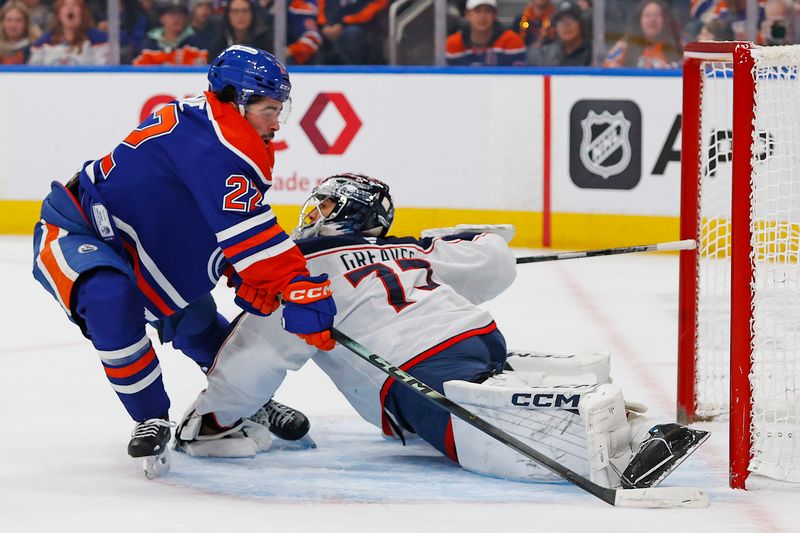Nov 10, 2025; Edmonton, Alberta, CAN; Columbus Blue Jackets goaltender Jet Greaves (73) makes a save on Edmonton Oilers forward Matt Savoie (22) during the first period at Rogers Place. Mandatory Credit: Perry Nelson-Imagn Images