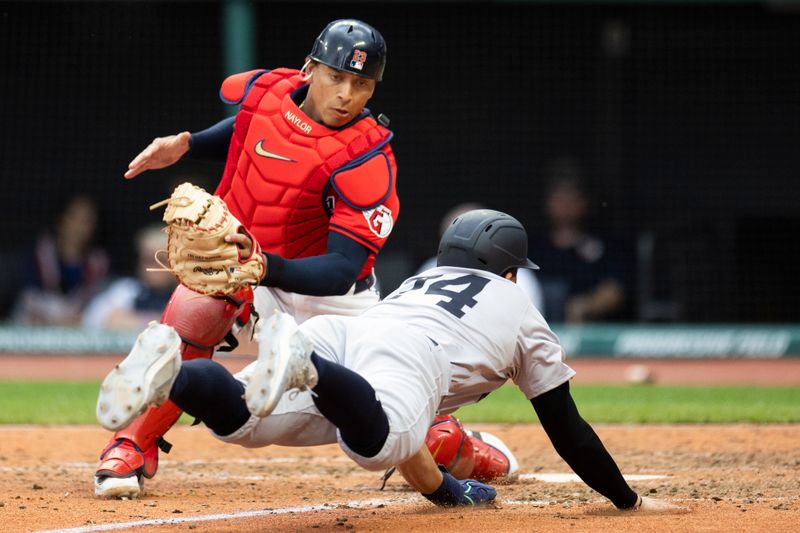 Apr 14, 2024; Cleveland, Ohio, USA; Cleveland Guardians catcher Bo Naylor (23) tags out New York Yankees infielder Kevin Smith (74) for the second out of the tenth inning at Progressive Field. Mandatory Credit: Scott Galvin-USA TODAY Sports