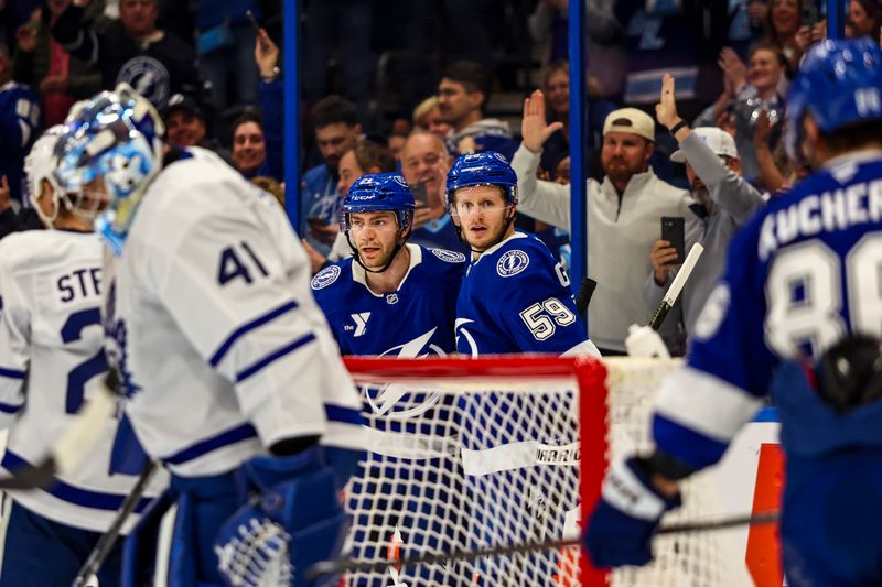 Feb 25, 2026; Tampa, Florida, USA; Tampa Bay Lightning  forward Brayden Point (21) and forward Jake Guentzel (59) celebrate a goal that was later called off against Toronto Maple Leafs during the first period at Benchmark International Arena. Mandatory Credit: Morgan Tencza-Imagn Images
