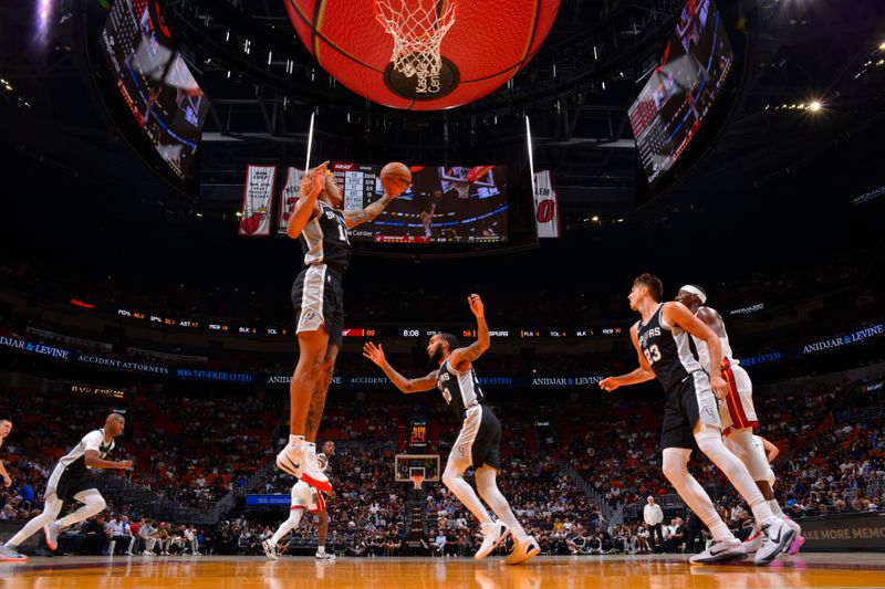 MIAMI, FL - OCTOBER 15: Jeremy Sochan #10 of the San Antonio Spurs rebounds the ball during the game against the Miami Heat during a NBA preseason game on October 15, 2024 at Kaseya Center in Miami, Florida. NOTE TO USER: User expressly acknowledges and agrees that, by downloading and or using this Photograph, user is consenting to the terms and conditions of the Getty Images License Agreement. Mandatory Copyright Notice: Copyright 2024 NBAE (Photo by Jesse D. Garrabrant/NBAE via Getty Images)