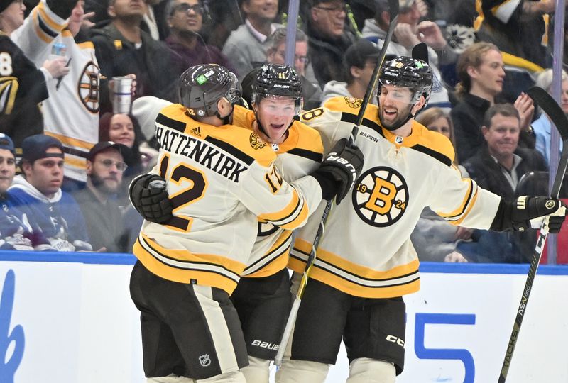 Dec 2, 2023; Toronto, Ontario, CAN; Boston Bruins forward Trent Frederic (11) celebrates with defensemen Kevin Shattenkirk (12) and Derek Forbort (28) after scoring against the Toronto Maple Leafs in the third period at Scotiabank Arena. Mandatory Credit: Dan Hamilton-USA TODAY Sports