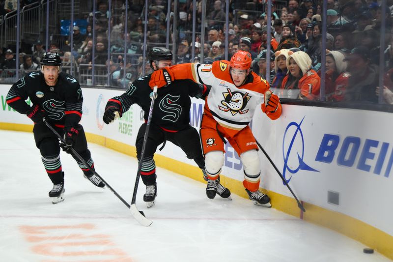 Jan 23, 2026; Seattle, Washington, USA; Seattle Kraken center Shane Wright (51) and Anaheim Ducks defenseman Olen Zellweger (51) chase the loose puck during the second period at Climate Pledge Arena. Mandatory Credit: Steven Bisig-Imagn Images