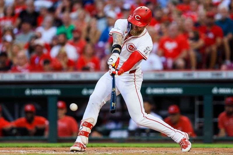 Aug 14, 2024; Cincinnati, Ohio, USA; Cincinnati Reds outfielder Jake Fraley (27) hits a RBI single in the fifth inning against the St. Louis Cardinals at Great American Ball Park. Mandatory Credit: Katie Stratman-USA TODAY Sports