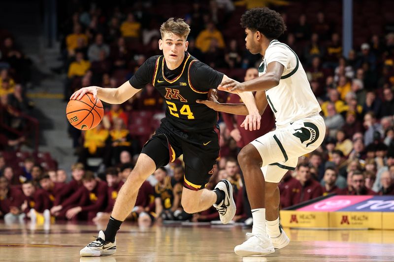 Dec 4, 2024; Minneapolis, Minnesota, USA; Minnesota Golden Gophers guard Brennan Rigsby (24) works around Michigan State Spartans guard Jase Richardson (11) during the first half at Williams Arena. Mandatory Credit: Matt Krohn-Imagn Images