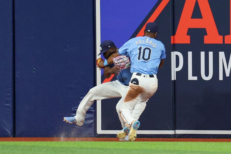 Apr 24, 2024; St. Petersburg, Florida, USA;  Tampa Bay Rays outfielder Amed Rosario (10) collides with outfielder Randy Arozarena (56) after making a catch against the Detroit Tigers in the fifth inning at Tropicana Field. Mandatory Credit: Nathan Ray Seebeck-USA TODAY Sports