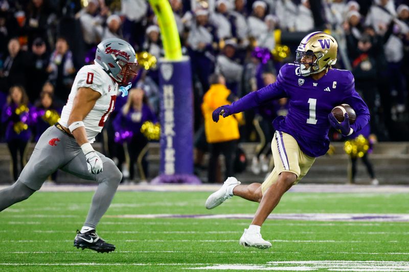 Nov 25, 2023; Seattle, Washington, USA; Washington Huskies wide receiver Rome Odunze (1) rushes against Washington State Cougars defensive back Sam Lockett III (0) during the fourth quarter at Alaska Airlines Field at Husky Stadium. Mandatory Credit: Joe Nicholson-USA TODAY Sports