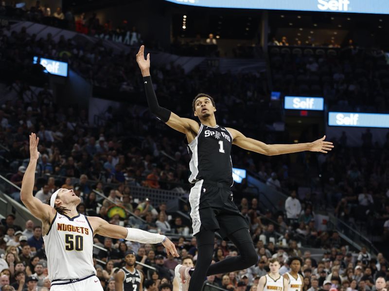 SAN ANTONIO, TX - APRIL 12: Victor Wembanyama #1 of the San Antonio Spurs causes an outlet pass to Aaron Gordon #50 of the Denver Nuggets to go out of bounds in the second half at Frost Bank Center on April 12, 2024 in San Antonio, Texas. NOTE TO USER: User expressly acknowledges and agrees that, by downloading and or using this photograph, User is consenting to terms and conditions of the Getty Images License Agreement. (Photo by Ronald Cortes/Getty Images)