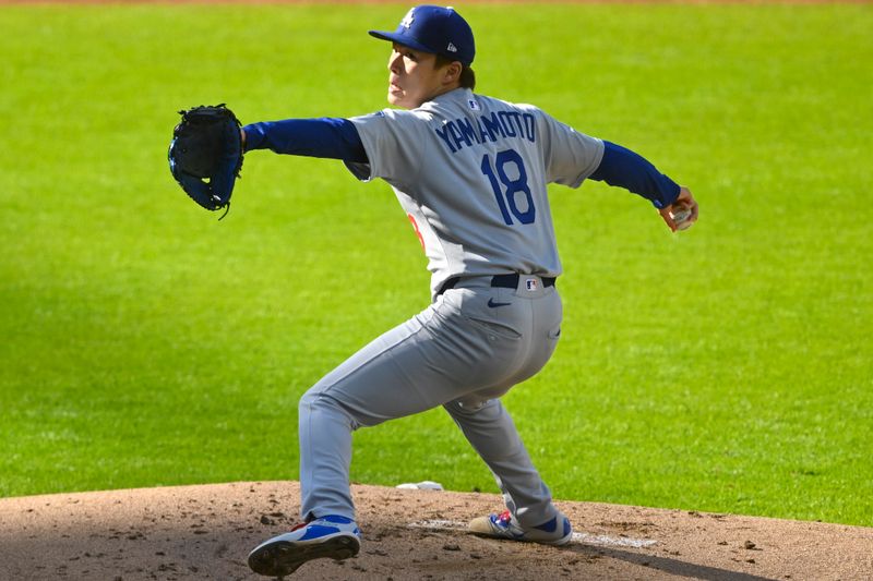 May 26, 2025; Cleveland, Ohio, USA; Los Angeles Dodgers starting pitcher Yoshinobu Yamamoto (18) delivers a pitch in the first inning against the Cleveland Guardians at Progressive Field. Mandatory Credit: David Richard-Imagn Images