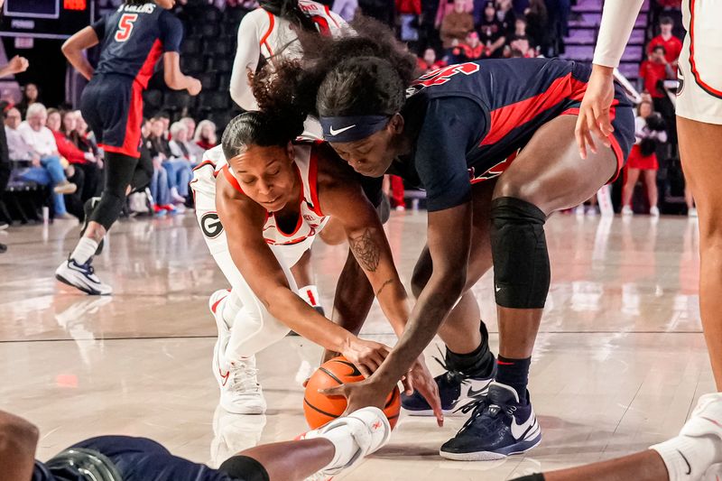 Jan 21, 2024; Athens, Georgia, USA; Georgia Bulldogs guard Asia Avinger (11) and Ole Miss Rebels center Rita Igbokwe (32) fight for the ball during the first half at Stegeman Coliseum. Mandatory Credit: Dale Zanine-USA TODAY Sports