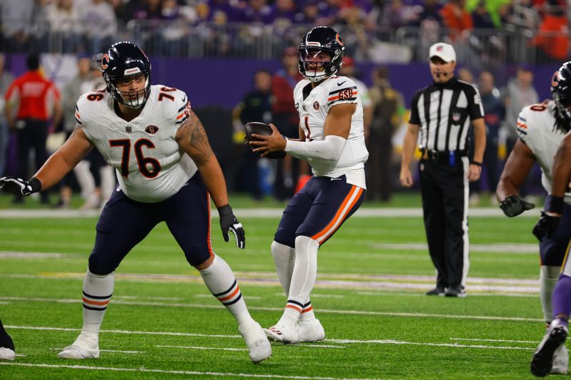 Chicago Bears quarterback Justin Fields (1) looks to pass during the first half of an NFL football game against the Minnesota Vikings, Monday, Nov. 27, 2023, in Minneapolis. (AP Photo/Bruce Kluckhohn)