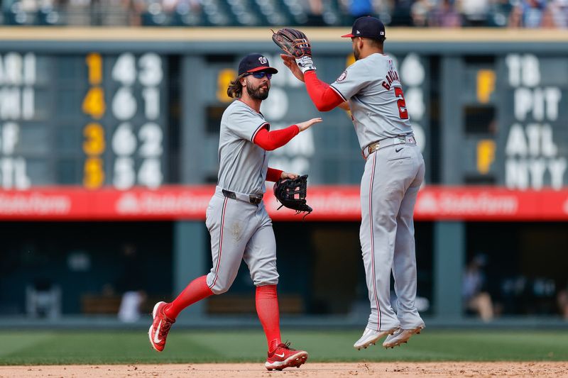 Jun 23, 2024; Denver, Colorado, USA; Washington Nationals left fielder Jesse Winker (6) and second baseman Luis Garcia Jr. (2) celebrate after the game against the Colorado Rockies at Coors Field. Mandatory Credit: Isaiah J. Downing-USA TODAY Sports