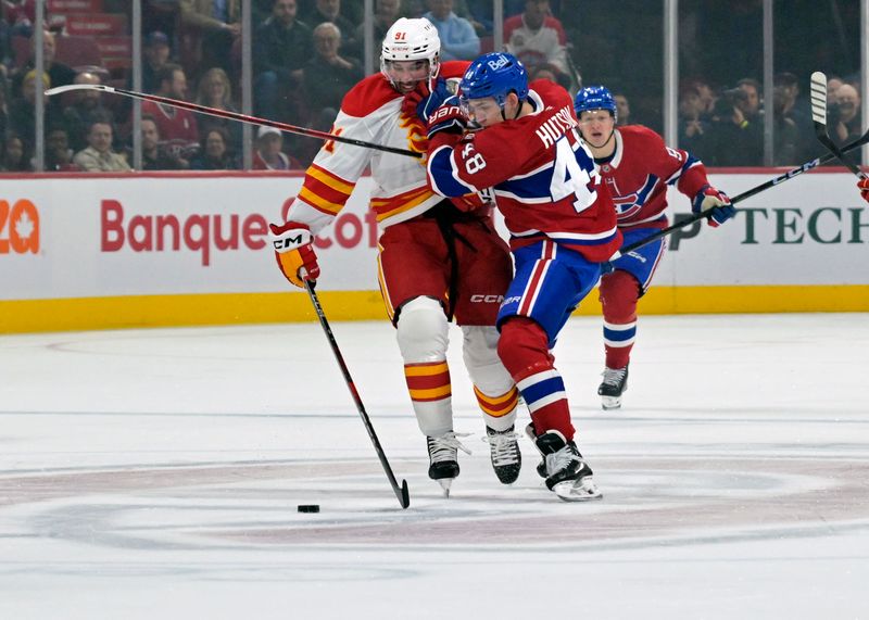 Nov 5, 2024; Montreal, Quebec, CAN; Montreal Canadiens defenseman Lane Hutson (48) takes the puck away from Calgary Flames forward Nazem Kadri (91) during the first period at the Bell Centre. Mandatory Credit: Eric Bolte-Imagn Images