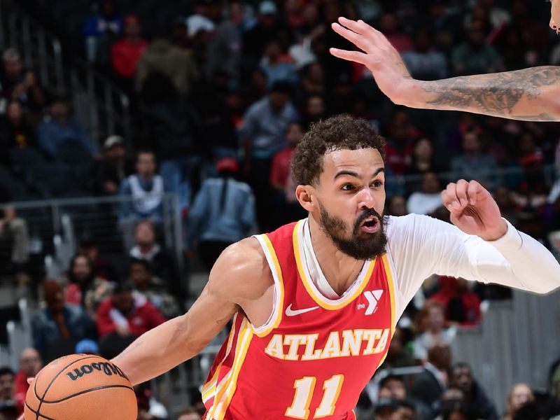 ATLANTA, GA - MARCH 04:  Trae Young #11 of the Atlanta Hawks handles the ball during the game against the Milwaukee Bucks on March 4, 2025 at State Farm Arena in Atlanta, Georgia.  NOTE TO USER: User expressly acknowledges and agrees that, by downloading and/or using this Photograph, user is consenting to the terms and conditions of the Getty Images License Agreement. Mandatory Copyright Notice: Copyright 2025 NBAE (Photo by Scott Cunningham/NBAE via Getty Images)