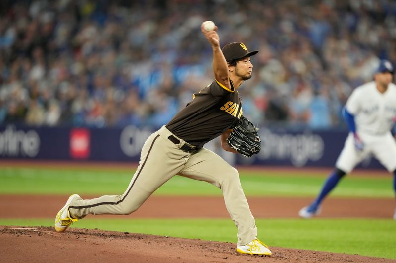 Jul 19, 2023; Toronto, Ontario, CAN; San Diego Padres starting pitcher Yu Darvish (11) pitches to the Toronto Blue Jays during the first inning at Rogers Centre. Mandatory Credit: John E. Sokolowski-USA TODAY Sports