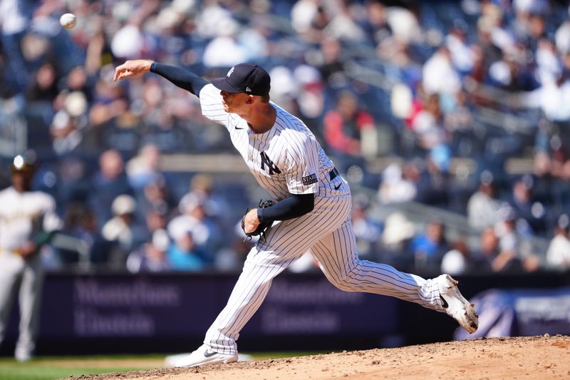 Apr 22, 2024; Bronx, New York, USA; New York Yankees pitcher Ian Hamilton (71) delivers against the Oakland Athletics during the eighth inning at Yankee Stadium. Mandatory Credit: Gregory Fisher-USA TODAY Sports