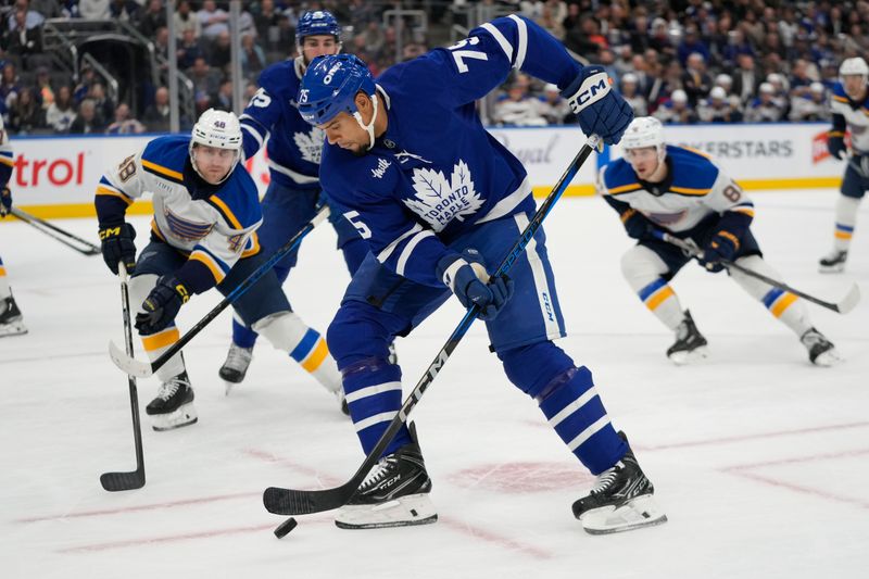 Oct 24, 2024; Toronto, Ontario, CAN; Toronto Maple Leafs forward Ryan Reaves (75) carries the puck against the St. Louis Blues during the third period at Scotiabank Arena. Mandatory Credit: John E. Sokolowski-Imagn Images