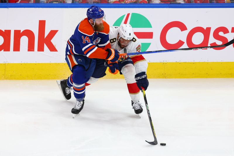 Jun 15, 2024; Edmonton, Alberta, CAN; Florida Panthers right wing Kyle Okposo (8) skates with the puck defended by by Edmonton Oilers defenseman Mattias Ekholm (14) in the second period in game four of the 2024 Stanley Cup Final at Rogers Place. Mandatory Credit: Sergei Belski-USA TODAY Sports