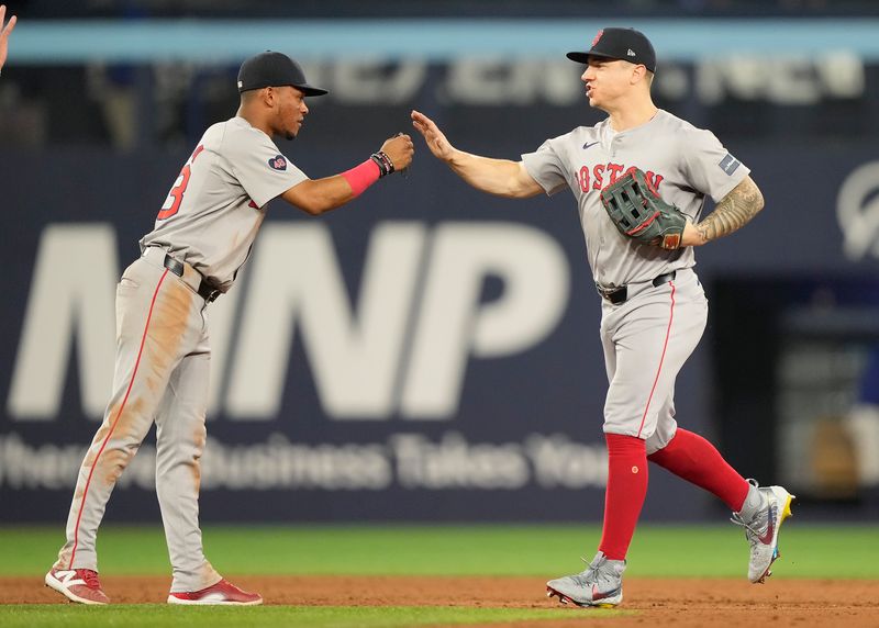 Jun 18, 2024; Toronto, Ontario, CAN; Boston Red Sox shortstop Ceddanne Rafaela (left) and left fielder Tyler O'Neill (right) celebrate a win over the Toronto Blue Jays at Rogers Centre. Mandatory Credit: John E. Sokolowski-USA TODAY Sports