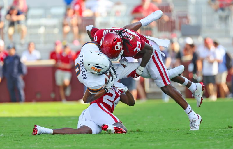 Sep 3, 2022; Norman, Oklahoma, USA;  Oklahoma Sooners defensive back Justin Harrington (37) and Oklahoma Sooners defensive back Gentry Williams (24) tackle UTEP Miners wide receiver Jeremiah Ballard (0) at Gaylord Family-Oklahoma Memorial Stadium. Mandatory Credit: Kevin Jairaj-USA TODAY Sports