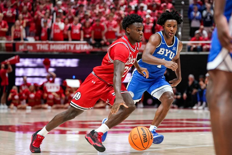 Jan 10, 2026; Salt Lake City, Utah, USA; Utah Utes guard Obomate Abbey (21) drives to the basket during the second half against the BYU Cougars at Jon M. Huntsman Center. Mandatory Credit: Aaron Baker-Imagn Images
