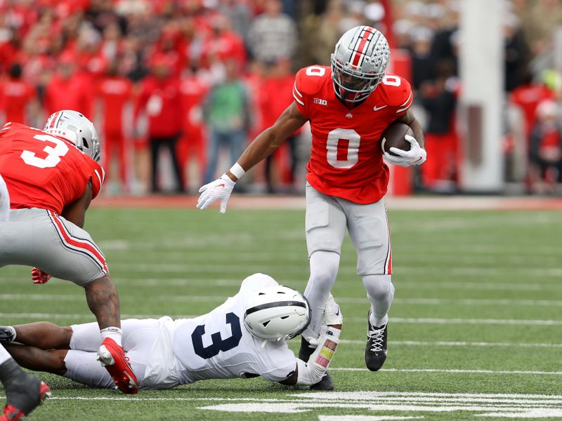 Oct 21, 2023; Columbus, Ohio, USA; Penn State Nittany Lions cornerback Johnny Dixon (3) tackles Ohio State Buckeyes wide receiver Xavier Johnson (0) during the third quarter at Ohio Stadium. Mandatory Credit: Joseph Maiorana-USA TODAY Sports