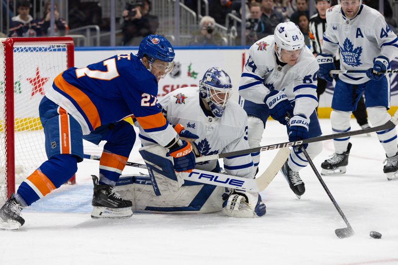 Dec 11, 2023; Elmont, New York, USA; Toronto Maple Leafs goaltender Ilya Samsonov (35) tracked the puck while New York Islanders left wing Anders Lee (27) attempts to score during the second period at UBS Arena. Mandatory Credit: Thomas Salus-USA TODAY Sports