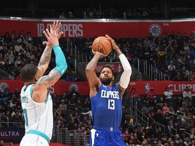 LOS ANGELES, CA - DECEMBER 26:  Paul George #13 of the LA Clippers shoots a three point basket during the game  on December 26, 2023 at Crypto.Com Arena in Los Angeles, California. NOTE TO USER: User expressly acknowledges and agrees that, by downloading and/or using this Photograph, user is consenting to the terms and conditions of the Getty Images License Agreement. Mandatory Copyright Notice: Copyright 2023 NBAE (Photo by Juan Ocampo/NBAE via Getty Images)